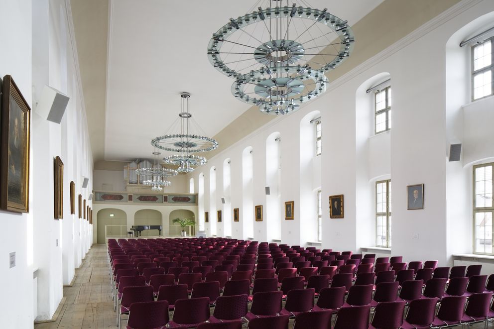 View of the fully seated Freylinghausen Hall in the Historical Orphanage of the Francke Foundations in Halle (Saale), facing the stage.
