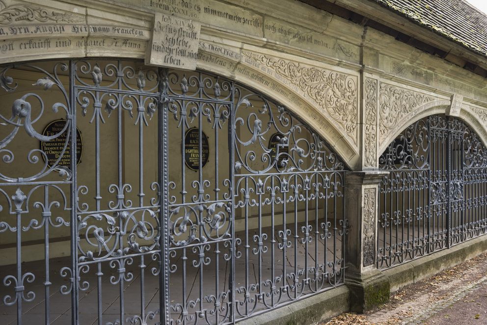 Blick durch ein Eisengitter in eine Gruft auf dem Stadtgottesacker in Halle