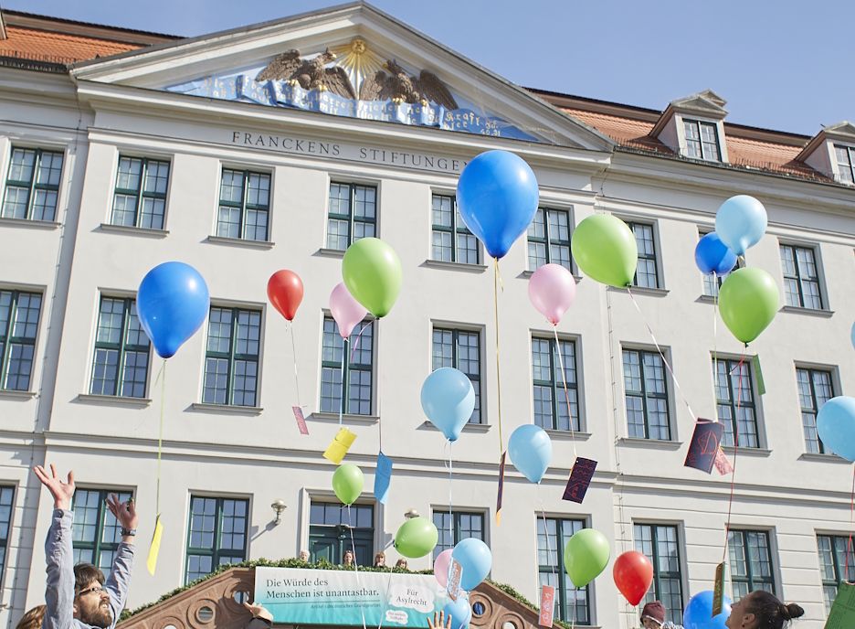 In front of the façade of the Historic Orphanage, colorful balloons with drawings and wishes from the children of the Krokoseum rise into the sky