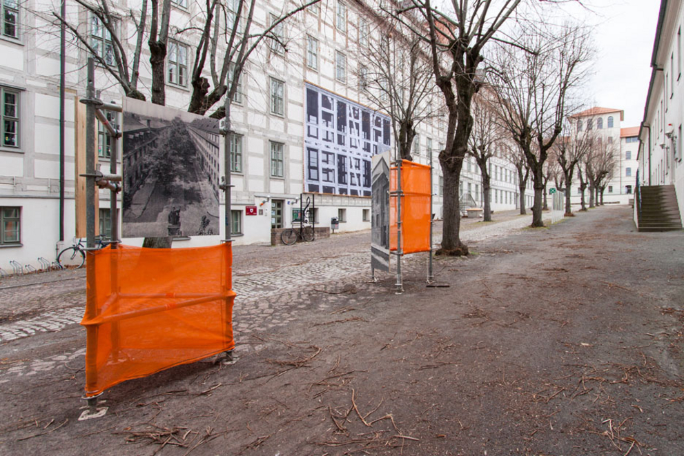 View into the Lindenhof with two information pillars of the open-air exhibition.