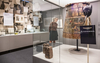 Eine Frau betrachtet Ausstellungsobjekte in einer Vitrine