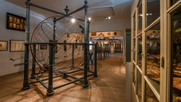 Blick in die Kunst- und Naturalienkammer mit dem Weltenmodell und den historischen Sammlungsschränken.