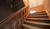 View of the worn wooden steps of the rear staircase in the printing works building.